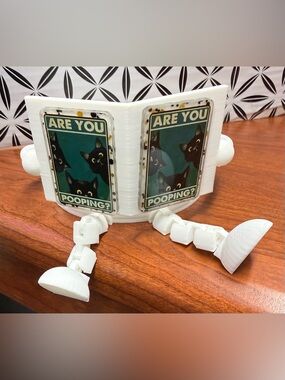Toilet paper holder with funny book cover